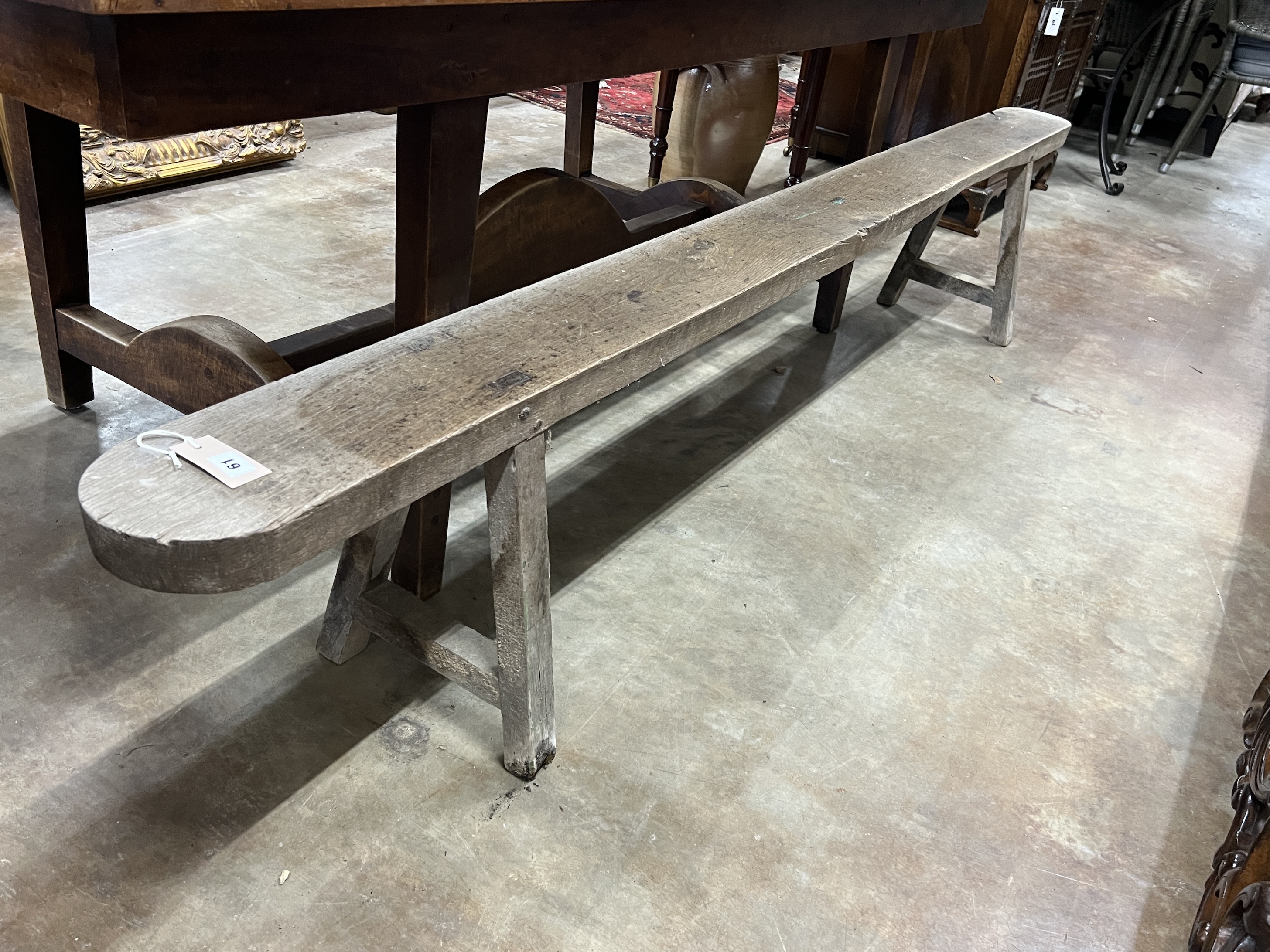 A 19th century French oak bench seat, length 251cm, depth 17cm, height 45cm